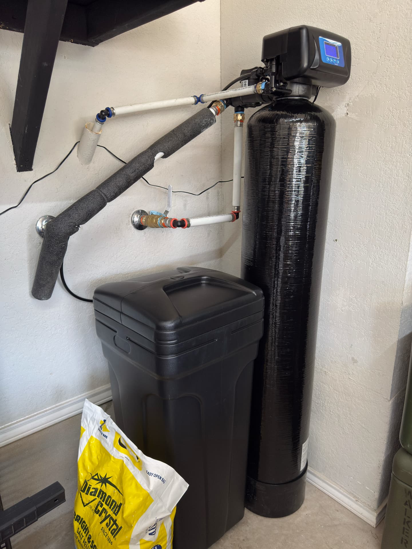 Water softener installed in a compact utility area